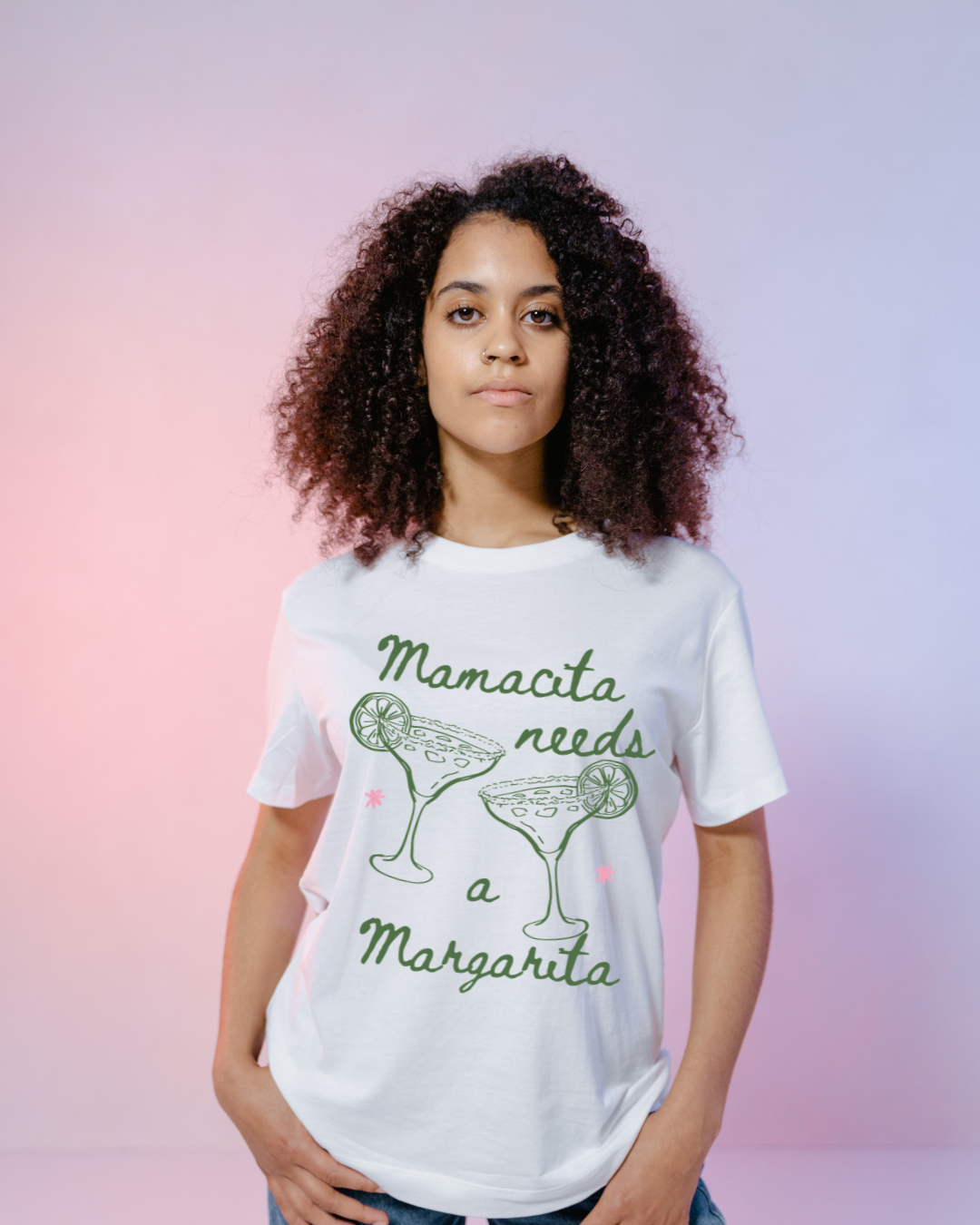 Person wearing a white t-shirt with 'Mamacita needs a Margarita' text and graphic on a gradient background